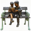 two children sitting on bench reading bronze statue sculpture